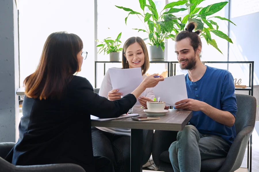 Buyer reviewing mortgage documents with a new lender before closing