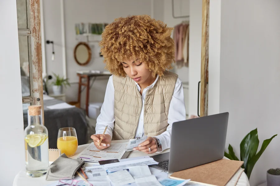 Couple reviewing debt and finances before applying for an FHA mortgage loan