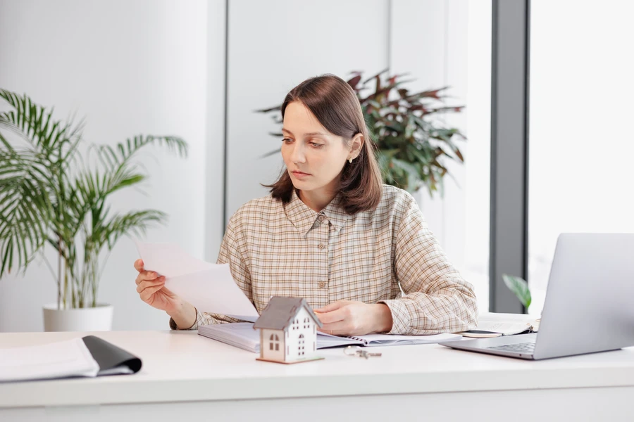 Mortgage underwriter reviewing loan file documents