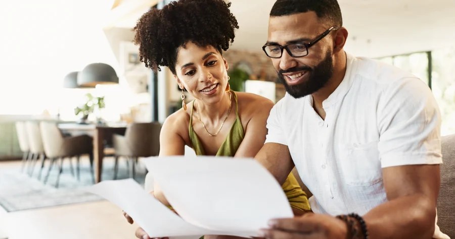 Mortgage borrower reviewing a Loan Estimate document at a desk