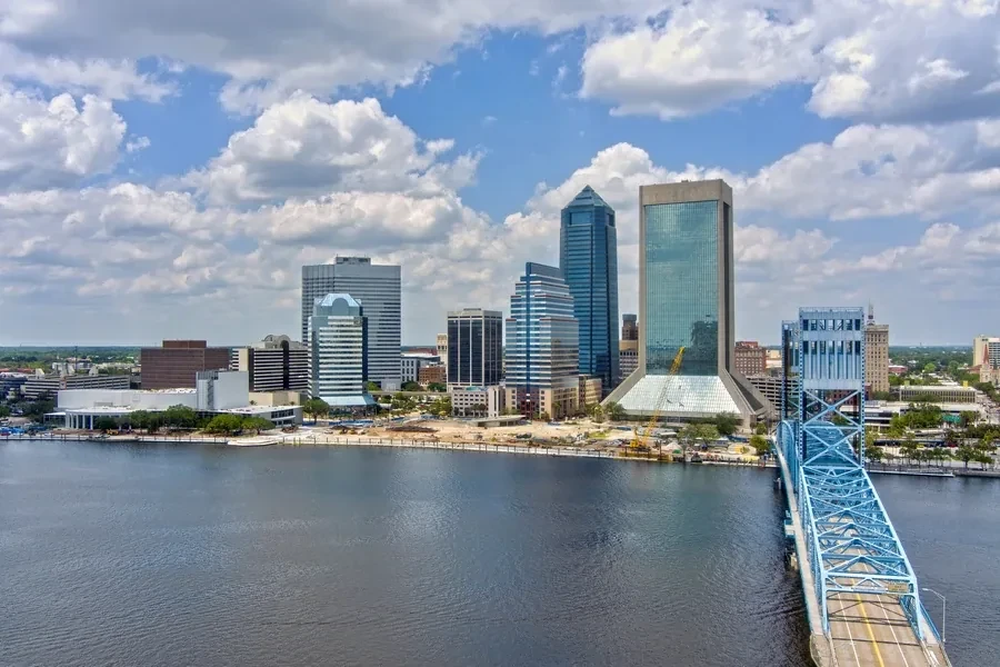 Jacksonville, Florida skyline at dusk with a bridge crossing the St. Johns River through downtown