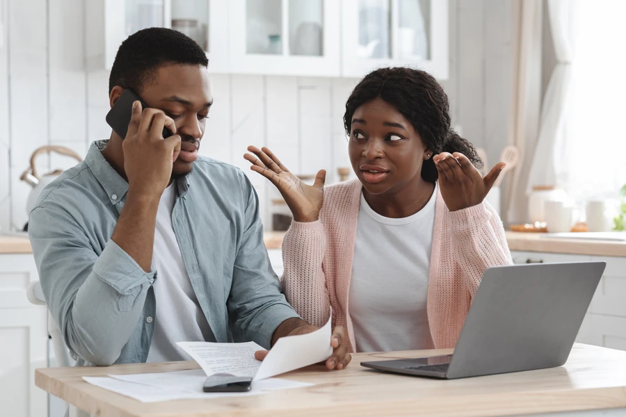 Stressed buyer on phone after mortgage lender backed out before closing