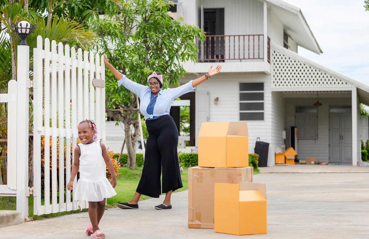 Family unpacking moving boxes in their new Florida home before the school year starts