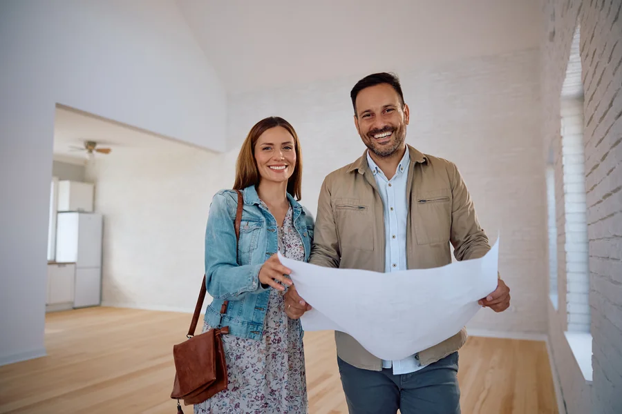 Couple reviewing blueprints with builder for new construction home in Florida