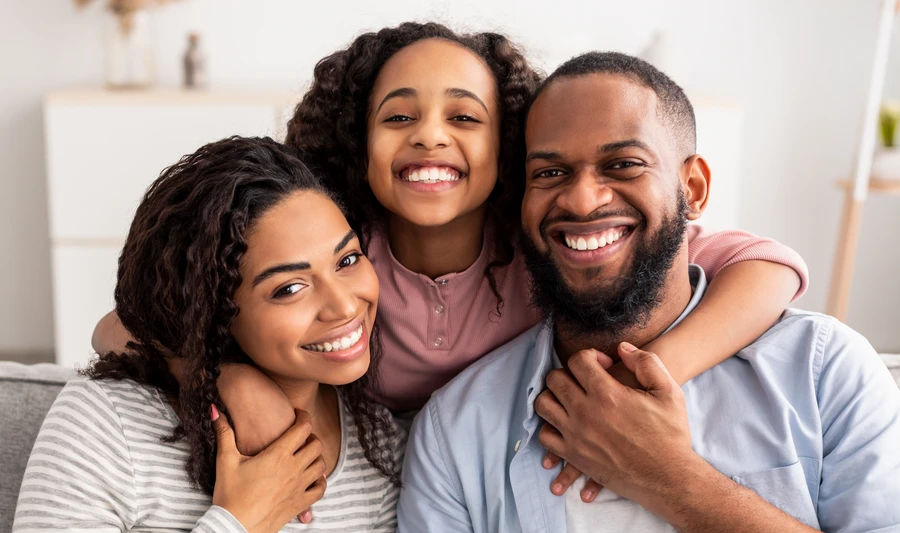 Happy Black family smiling together at home in Tampa Bay