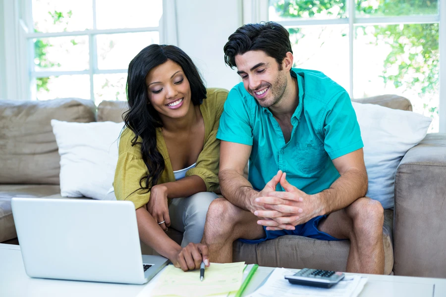 Young Florida couple reviewing savings plan on laptop to buy their first home