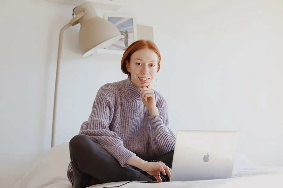 Self-employed borrower reviewing mortgage documents at a home office desk