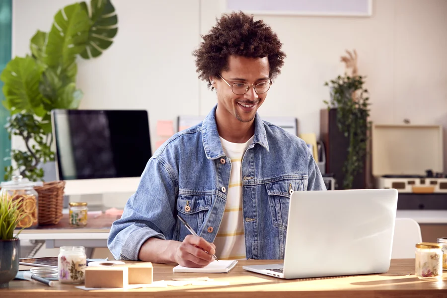 Self-employed man working on laptop reviewing mortgage options