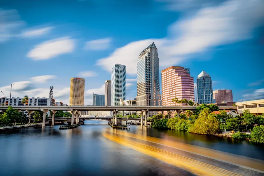 Tampa Florida skyline with the river and bridge under afternoon clouds during the fall home buying season