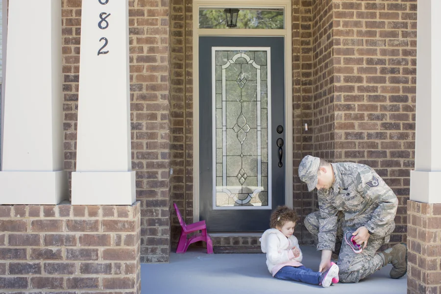 Military veteran family reviewing VA loan benefits with a mortgage lender