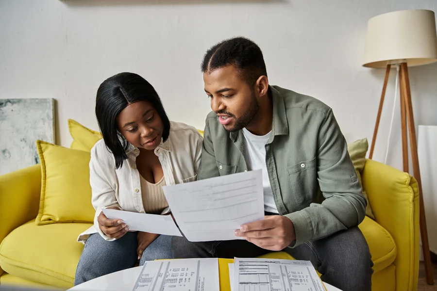 Florida homeowner reviewing mortgage escrow documents at kitchen table